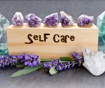 A wooden block that says "Self care,"