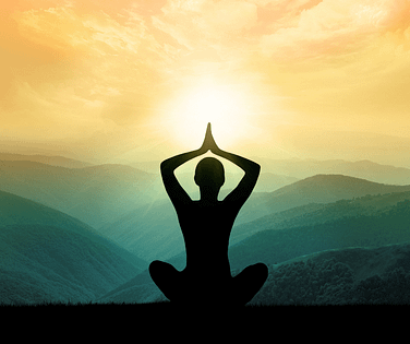 Girl meditating in front of mountains and sunshine,
