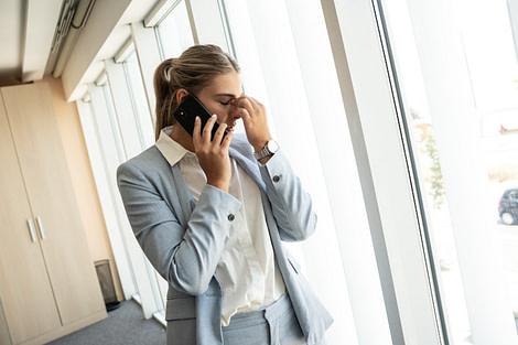 Anxiety_LocalTherapyKirklandWA_ShanaOlmstead Professional Woman Stressed On The Phone Anxiety Therapy