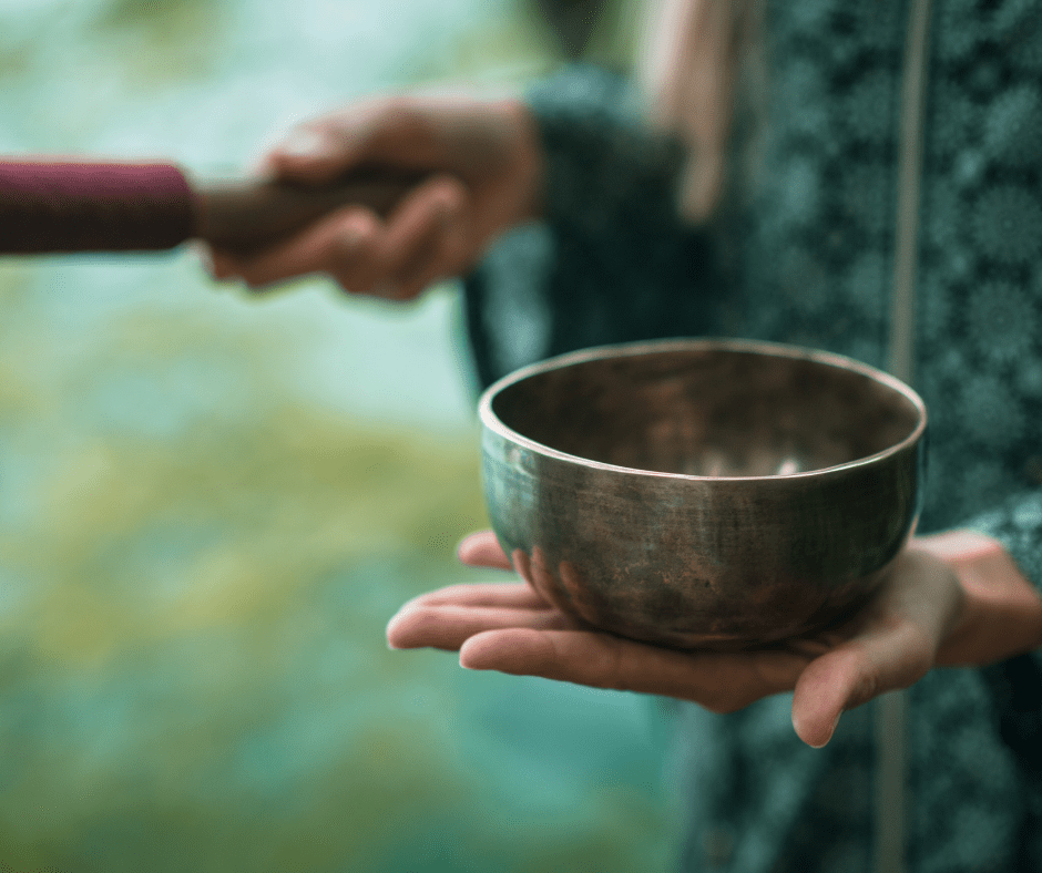 Woman playing a singing bowl